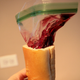 a ziploc bag filled with pie filling sticking out of a loaf of bread